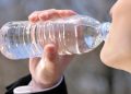 drinking water in a plastic bottle