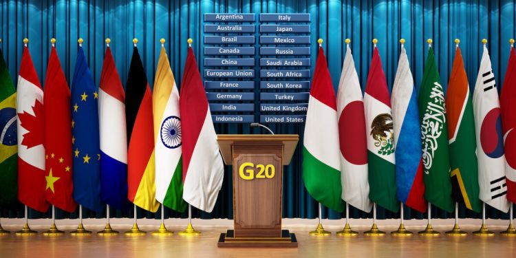 G20 country flags arranged in a conference room. 3D illustration.