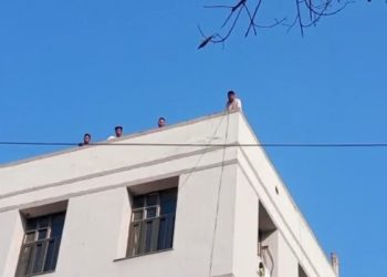 students climbed onto the roof of the college carrying petrol