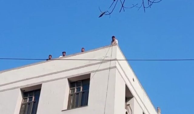 students climbed onto the roof of the college carrying petrol