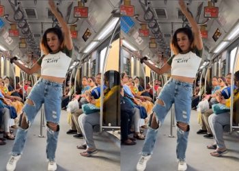 girl dancing in torn jeans in Delhi Metro